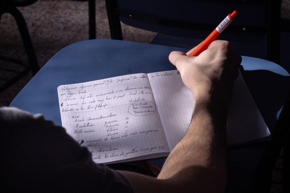 Person taking handwritten notes in a notebook