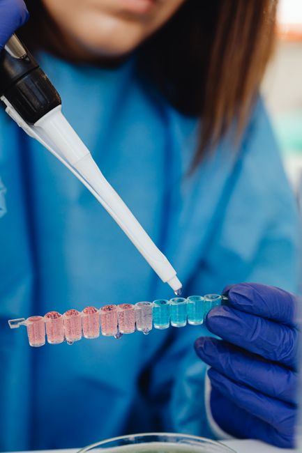 Scientist using a pipette with vials in a laboratory