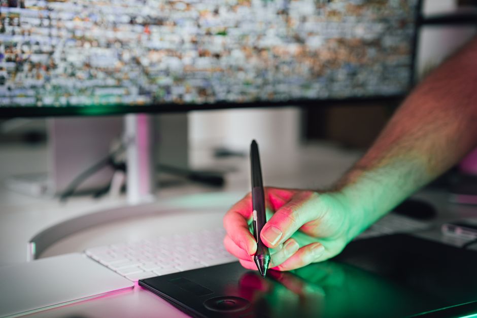 Digital artist using a graphics tablet in a modern workspace