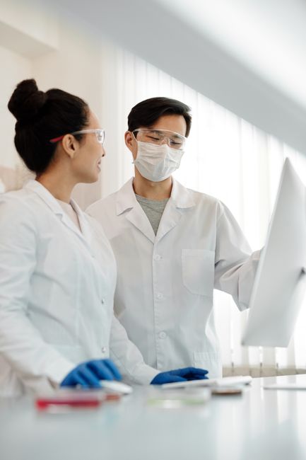 Two scientists discussing research results in a laboratory