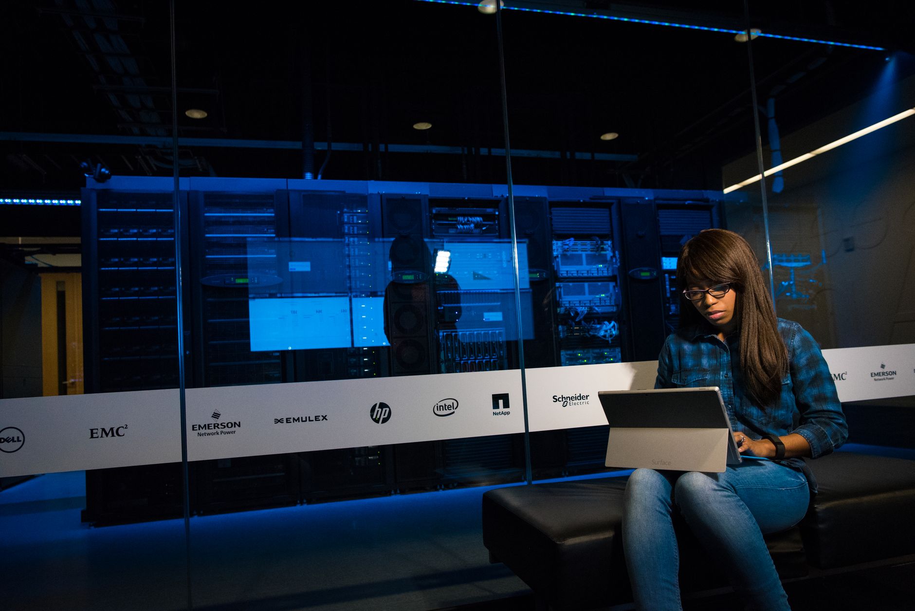 Person using a laptop in a server room