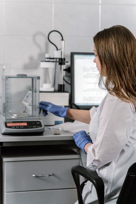 Woman in a lab coat conducting research with lab equipment