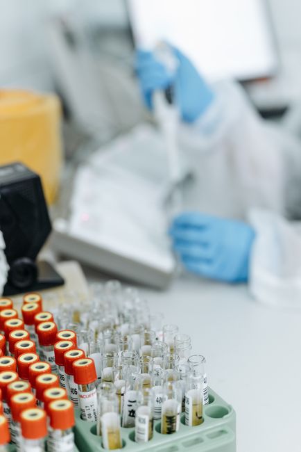 Researcher handling blood samples with a pipette in a laboratory