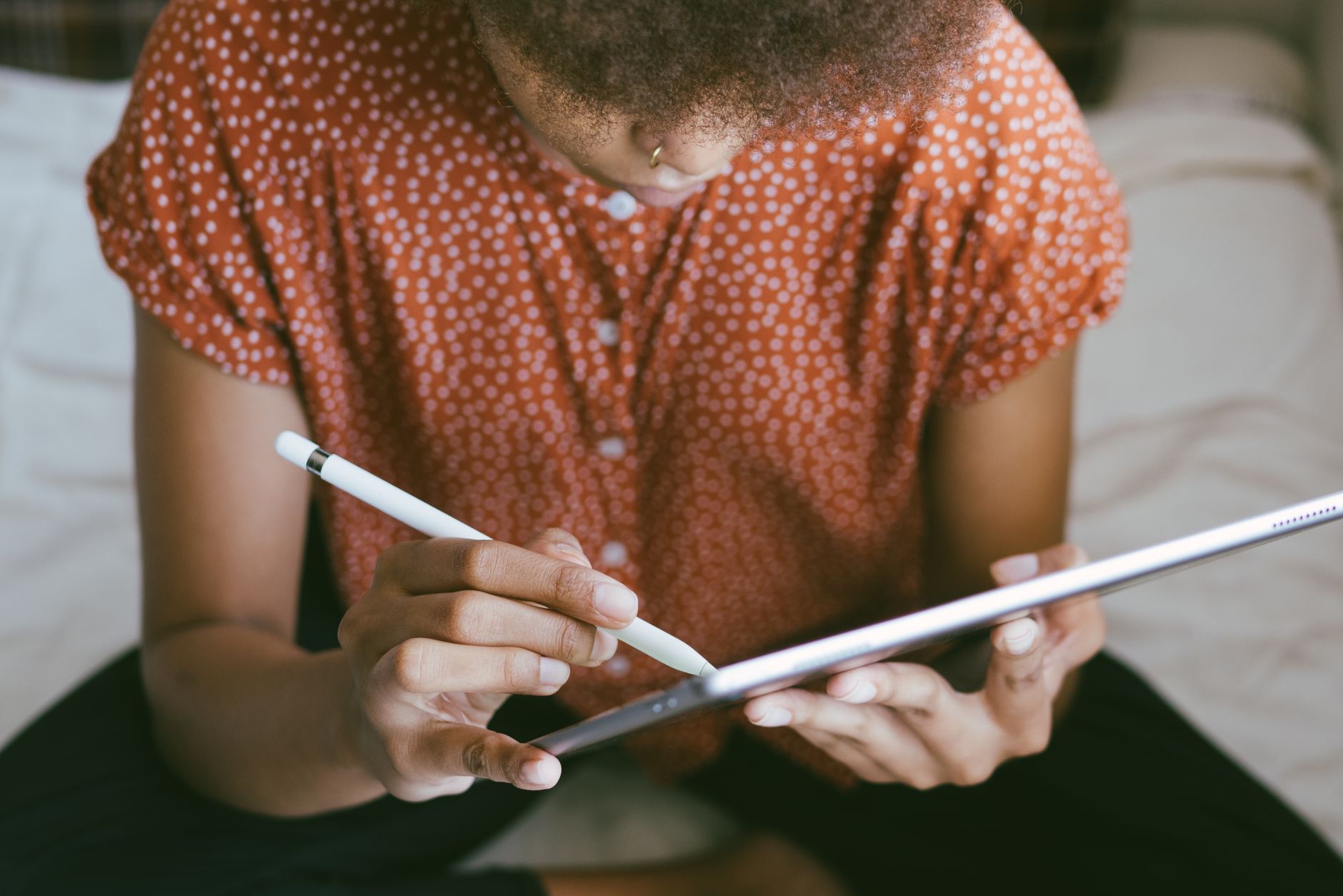 Person using a stylus to write on a digital tablet