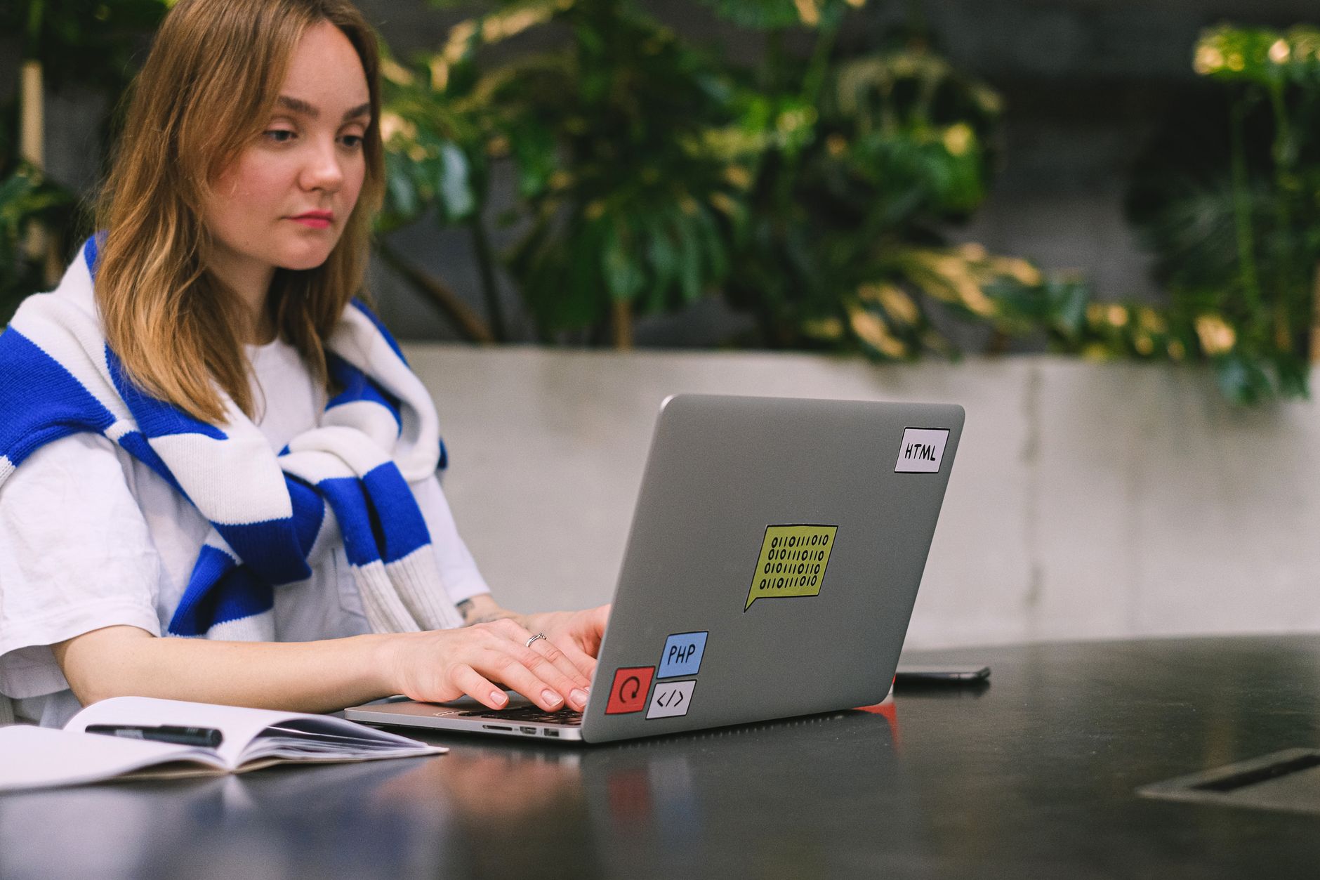 Person working on a laptop in a bright indoor space