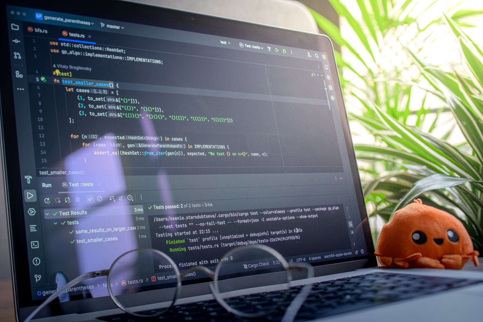 Laptop displaying code in a bright workspace