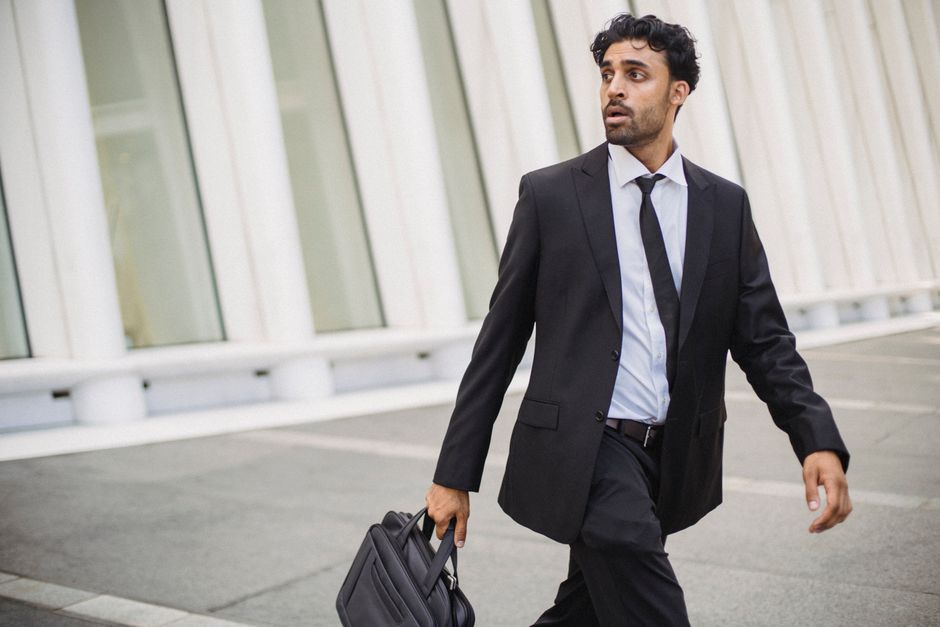 Businessman walking outside with a briefcase